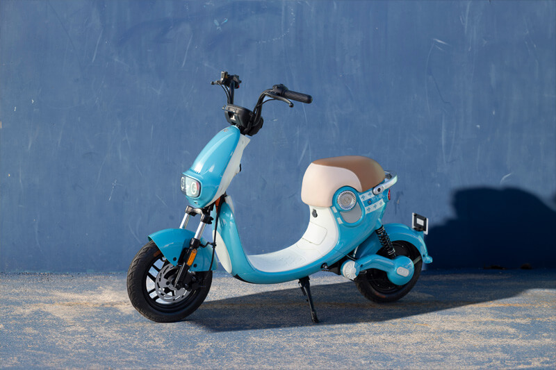 blue scooter with urban background